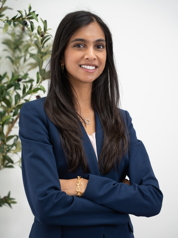 Dr. Leena Ramani at the front desk in a black blazer at Palm Beach Skin & Hair Restoration in Jupiter, FL