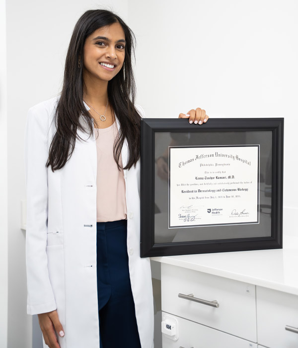 Dr. Leena Ramani with her degree at Palm Beach Skin & Hair Restoration in Jupiter, FL