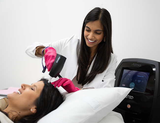 Dr. Ramani useing AlmaTED machine on female patients hair