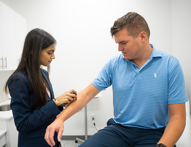 Dr. Leena Ramani with a patient at Palm Beach Skin & Hair Restoration in Jupiter, FL